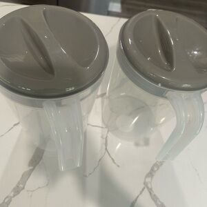 Set of Two Clear Pitchers with Gray Lids